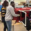 High school and college STEM students build electric cars for kids with disabilities for free